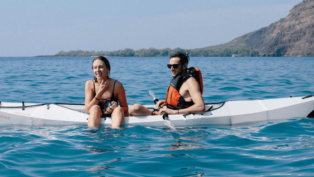 2 people sat in oru kayak beach lt