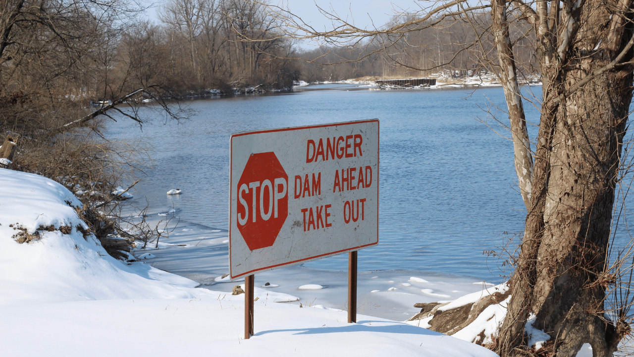 dam danger sign on a river