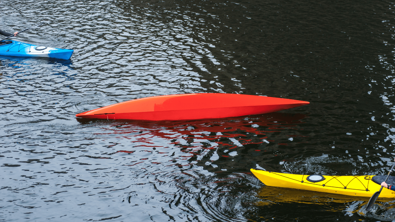 kayaker performs a float assisted eskimo roll