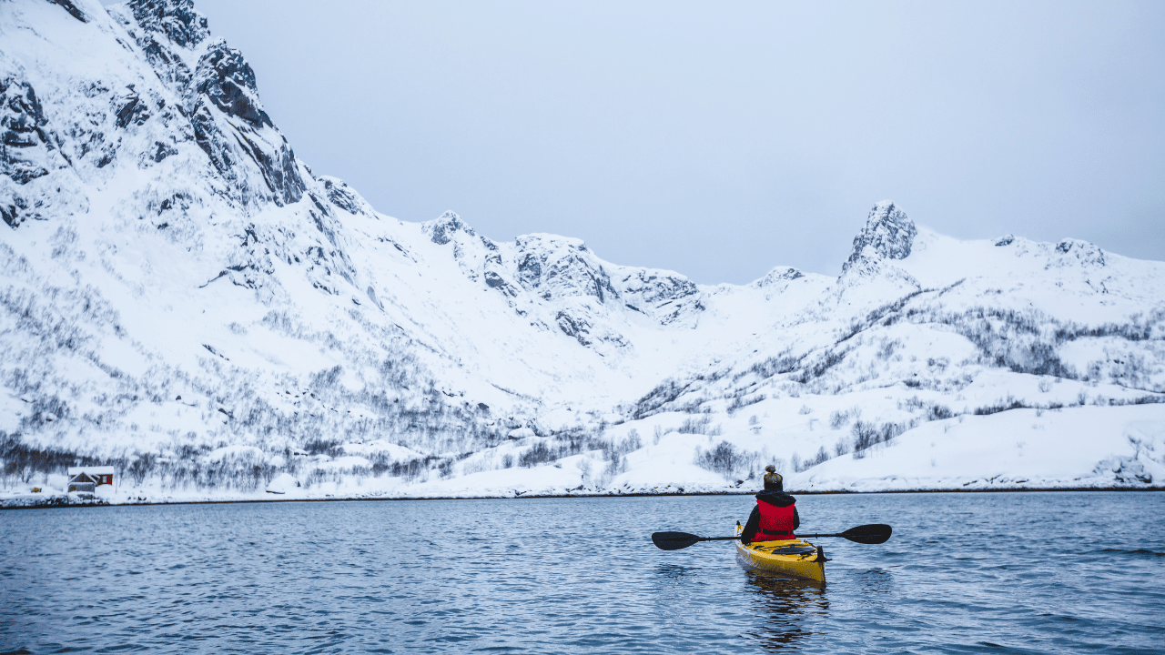 woman kayaking in Lofoten, Norway