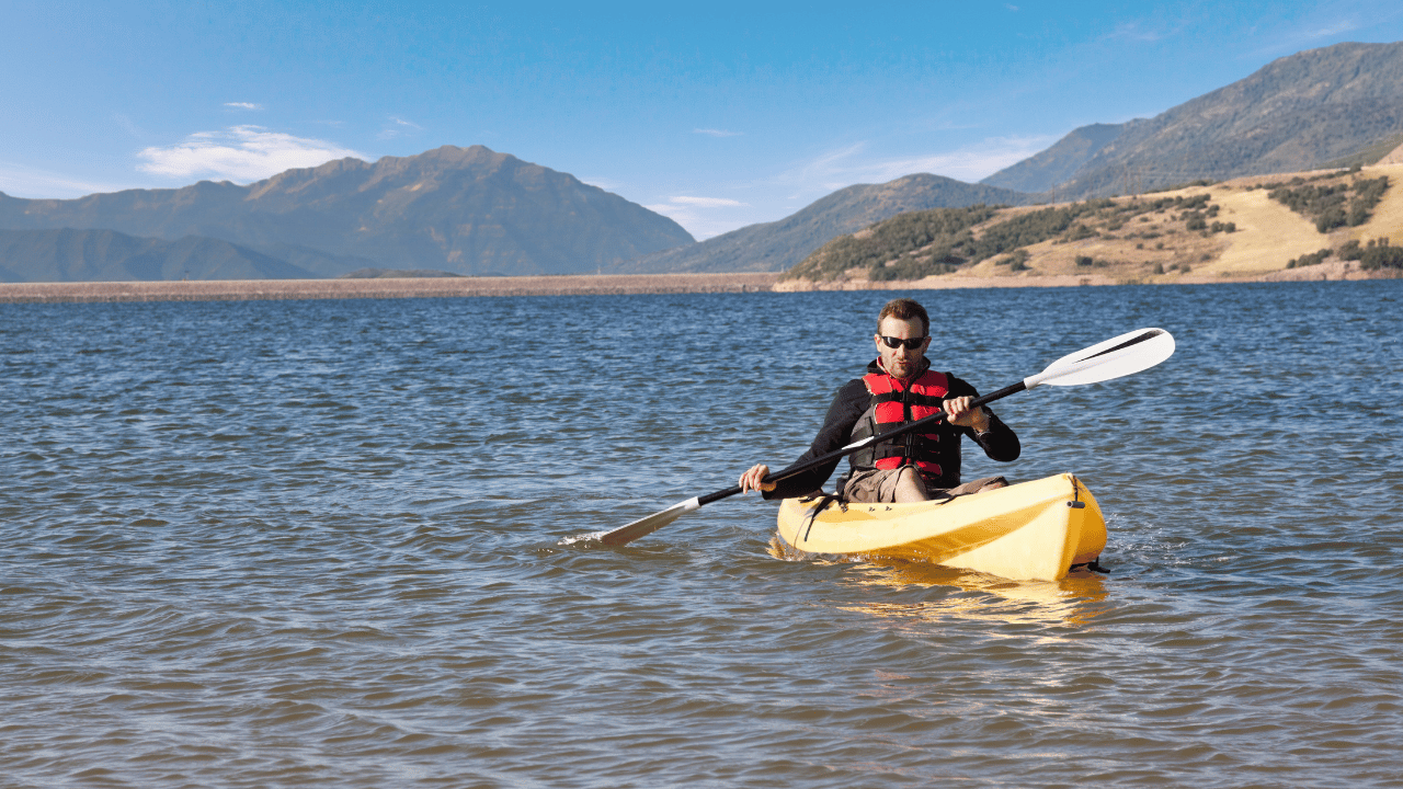 man kayaking on a lake
