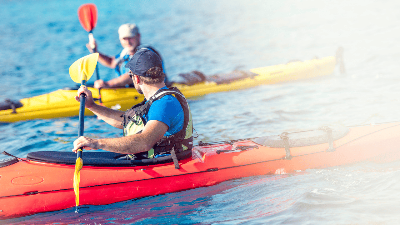 2 kayakers paddling in parallel in the sea