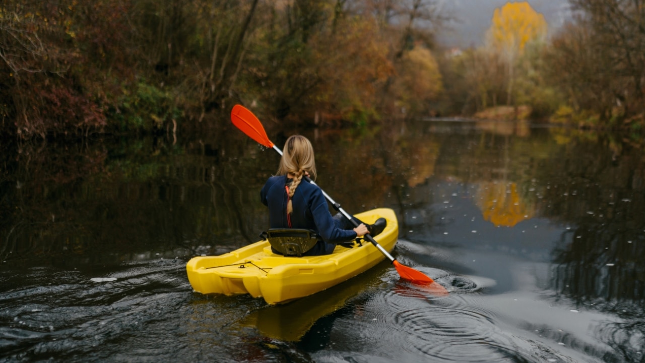 Woman kayaking on a river